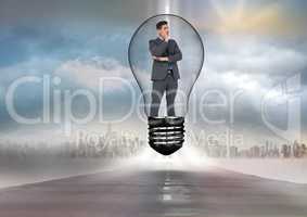 Digital image of businessman standing in bulb over road against city