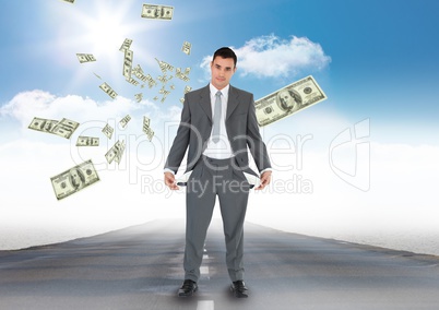 Businessman showing empty pockets while standing on road representing loss