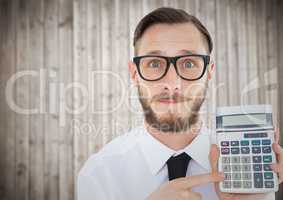 Man with calculator against blurry wood panel