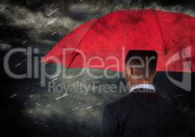 Back of business man with umbrella against rain and clouds with grunge overlay