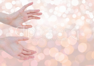 Hands open delicately with sparkling light bokeh background