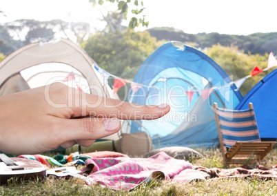 Hand touching air with festival camping background