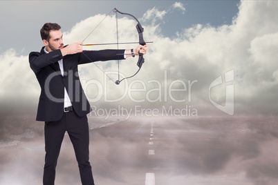 Side view of an archer shooting an arrow against road background