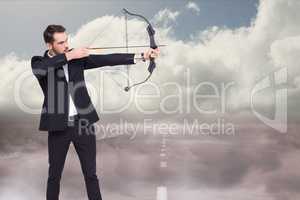 Side view of an archer shooting an arrow against road background