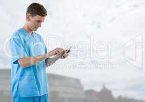 Doctor holding phone  with bright outside background
