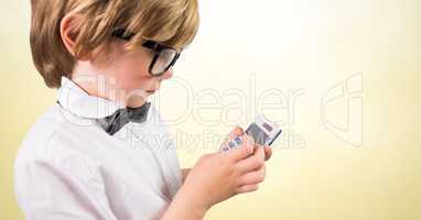Boy with calculator against yellow background