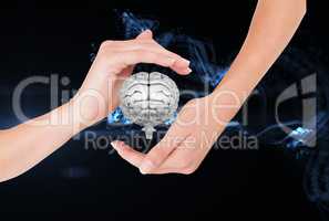 Brain on hands against black background