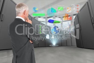 Reflective businessman in data center with digital icons
