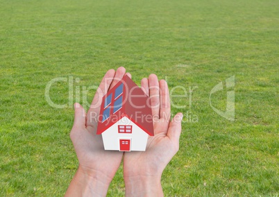 solar panel house with red roof on hands