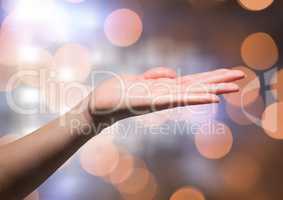 Hand open freely with sparkling light bokeh background