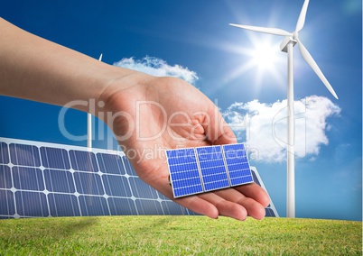 solar panel on hand in front of  different devices to renewable energy