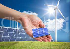 solar panel on hand in front of  different devices to renewable energy