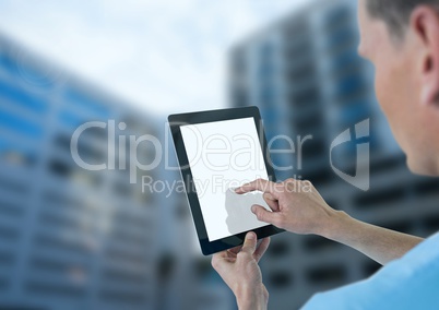 Doctor holding tablet with tall buildings