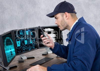 security guard with locks on the screens speaking with the walkie-talkie in his office