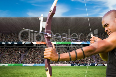 archer is shooting an arrow against stadium background
