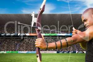 archer is shooting an arrow against stadium background