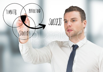 Business man drawing venn diagram doodle in blurry grey office