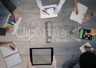 Overhead of business team with grey wood panel and idea doodle