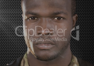 foreground of serious soldier looking us. Dark background and flares