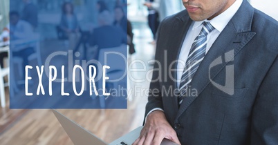Cropped image of businessman working on laptop standing by explore text in office