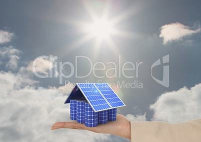 Digital image of solar panels on hand against sky