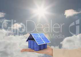 Digital image of solar panels on hand against sky