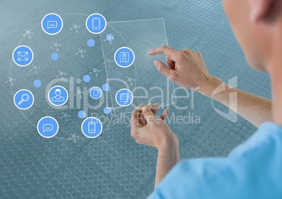 Doctor holding glass tablet with apps and blue background