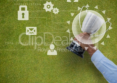 business hand with trophy in the grass with graphic