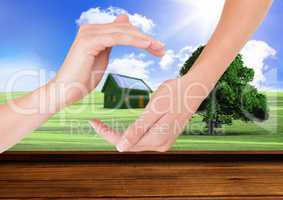 grass house with panels between hands in the field