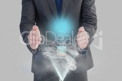 bulb on hands against grey background