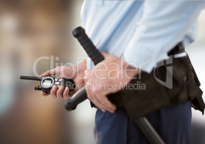 security guard with walkie-talkie. blurred back