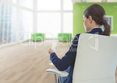 Businesswoman Back Sitting in Chair with drinks glass in office
