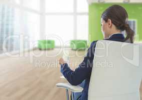 Businesswoman Back Sitting in Chair with drinks glass in office