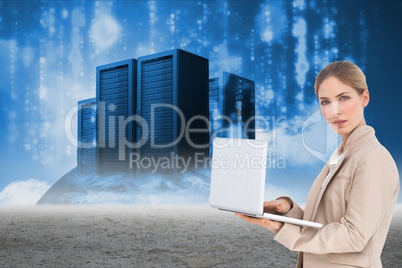 Businesswoman holding a laptop near to storage units