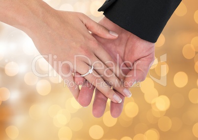 Couple Hands with ring wedding engagement with sparkling light bokeh background