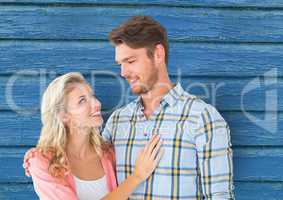 couple looking each other with blue wood background