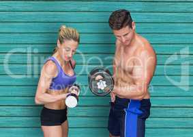fitness couple with wights with light blue wood background