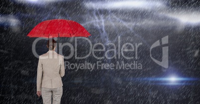 Digital composite image of businesswoman holding red umbrella while standing in rain