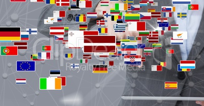 Digital composite image of various flags against businesswoman