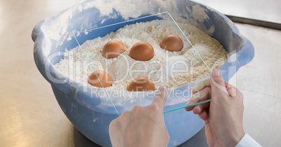 Cropped hands photographing eggs in flour through transparent device at bakery