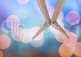 Hands open in a V shape with sparkling light bokeh background