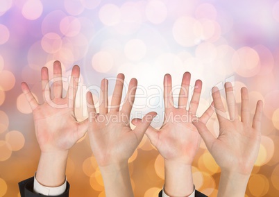 Many open Hands with sparkling light bokeh background