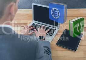 Businessman on laptop on desk with apps