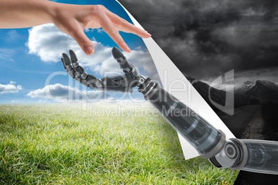 Human and robot touching their fingers between blue and grey sky