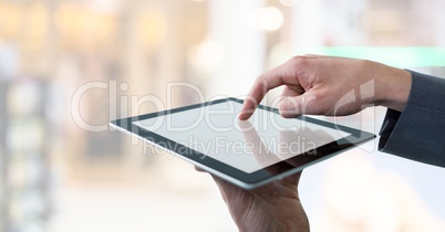 Businessman touching tablet in public