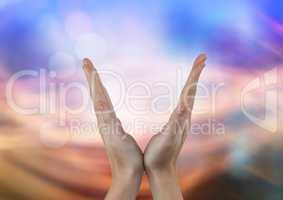 Hands in V shape with abstract light background