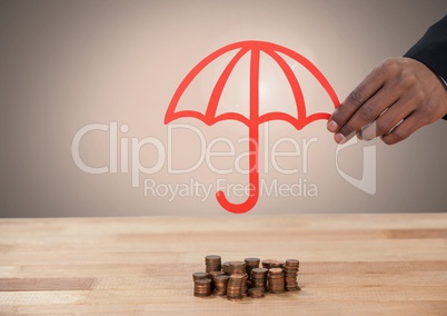 Cut out umbrella in hand protecting coins money