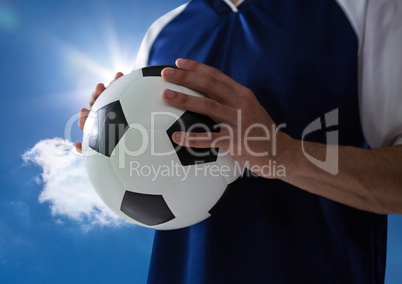 soccer player with ball on his hands with a blue sky