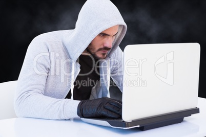 Cyber criminal is hacking from a laptop