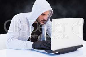Cyber criminal is hacking from a laptop